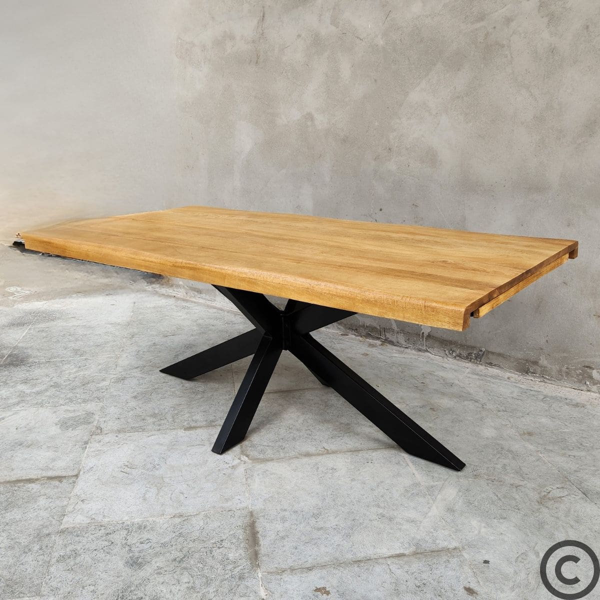 Grande table extensible en manguier massif avec pieds mikado en métal noir. La table KUKUU allie élégance et robustesse.